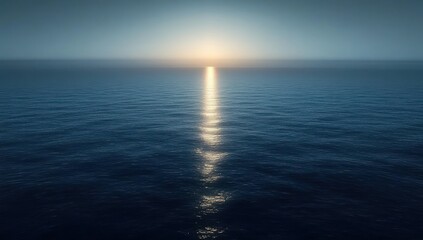 Obraz premium Calm ocean at sunrise with soft light reflecting on gentle waves under a clear sky evoking peace and tranquility