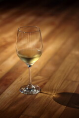 glass of chilled white wine on wooden table