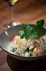 Risotto with arugula and shrimp, an Italian classic on a plate