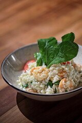 Risotto with arugula and shrimp, an Italian classic on a plate