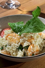 Risotto with arugula and shrimp, an Italian classic on a plate