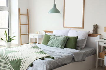 Interior of light bedroom with cozy bed, big window and houseplant