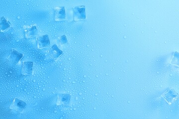 Cubes of clear ice on light blue background, flat lay. Space for text