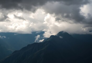 view of a mountain with clouds in the sky