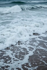 wave rolls in on a beach near the ocean