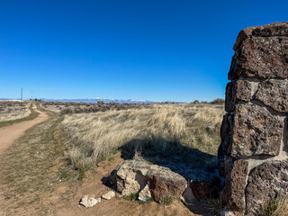 Rock pillar in agriculture farm rural field uncultivated blue sky sunny day no clouds