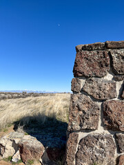 Rock pillar in agriculture farm rural field uncultivated blue sky sunny day no clouds