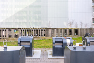 Public recycling and waste disposal area integrated into city landscape, reflecting organized environmental systems and sustainable urban development planning.