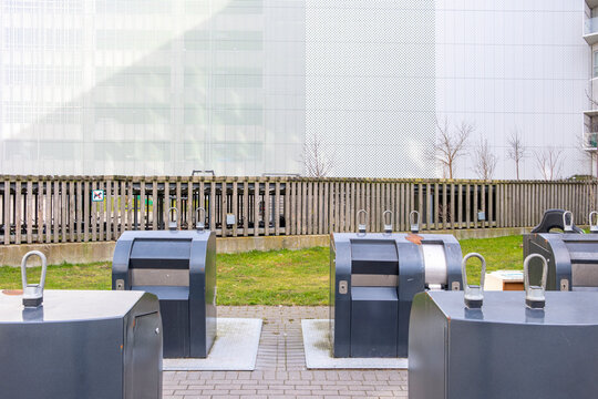 Public recycling and waste disposal area integrated into city landscape, reflecting organized environmental systems and sustainable urban development planning.