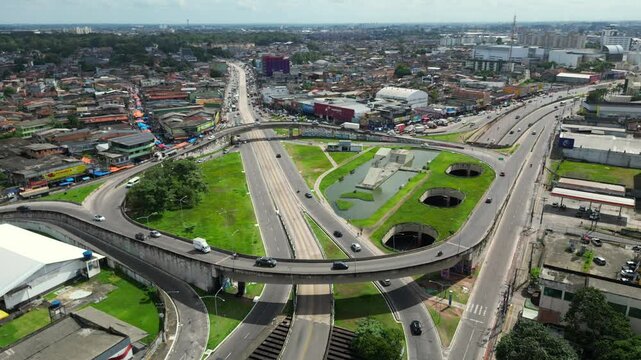 Aerial drone footage of a key road interchange in Belem, Para, BR, with overpasses and an underpass that integrate four major roads, a crucial connection between the city with surrounding regions