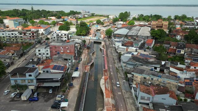 Aerial drone footage over the "Tamandare" canal in Belem, Para, BR, under construction works of a linear park, featuring revitalization of the canal, implementation of bike lanes and leisure spaces