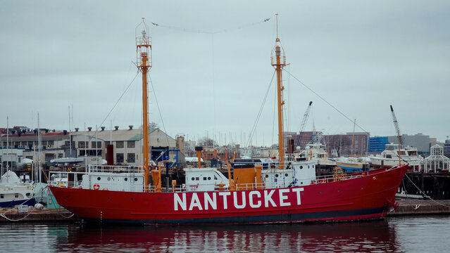 BOSTON, USA - APRIL 3, 2017 - Red and white lightship Nantucket I LV 112 moored in Boston Harbor, with cloudy sky