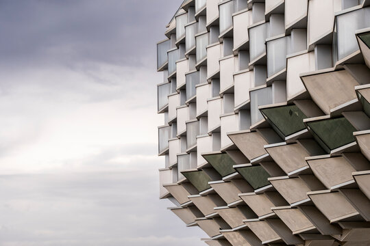 Close-up of modern facade with hexagonal window elements, showcasing abstract design, geometry and futuristic architectural surface textures.
