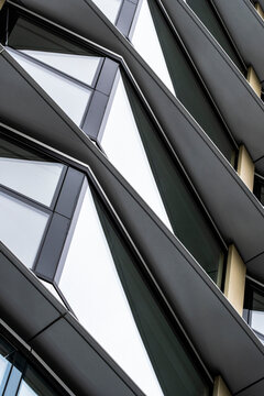 Structural detail of intersecting black steel frames and glass, focusing on engineering precision, modern materials and contemporary architectural composition.