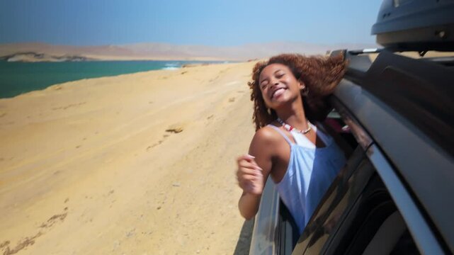 Young woman enjoying road trip along paracas coast