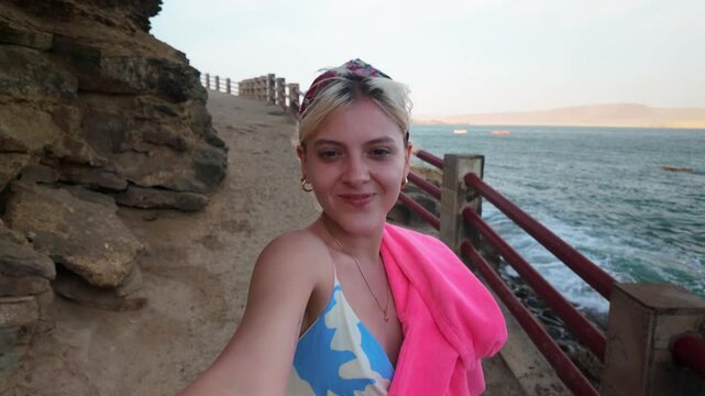 Tourist taking selfies at paracas national reserve cliff
