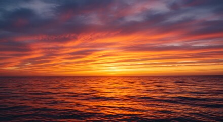 Fototapeta premium Fiery Sunset over Calm Ocean Waters: A Stunning Display of Nature's Hues