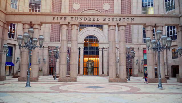 BOSTON, USA - APRIL 3, 2017 - Ornate columns and street lamps framing the entrance of Five Hundred Boylston, a postmodern office building in Boston's Back Bay