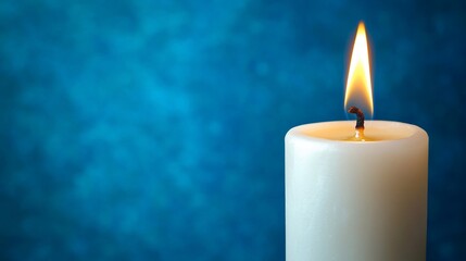 Single white candle flame against a teal backdrop