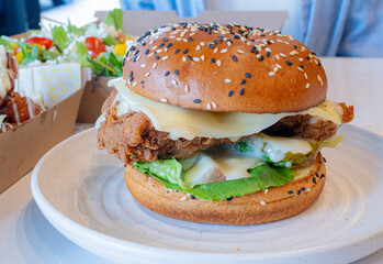Deep-fried boneless Korean chicken burger with sweet buns. Crispy outside, juicy and succulent...