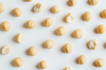 Light-tan shelled nuts arranged on white surface