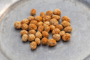 Close-up of dried plum fruit seeds on silverware. This fruit, also called Indian jujube, Chinese date, or Chinee apple, is locally known as Boroi or Kul in Bangladesh.