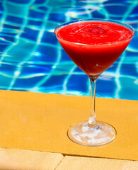 Strawberry Daiquiri cocktail and swimming pool