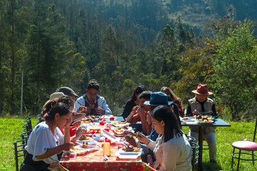Latin american family enjoying outdoor meal in mountain scenery