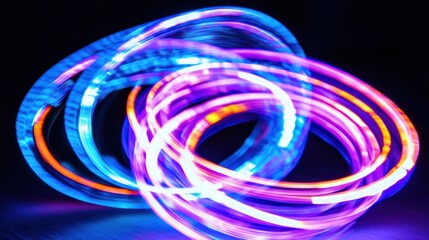 Multicolored light rings in a dynamic, swirling display.