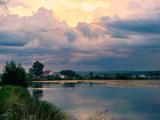 Majestic sunset over tranquil river with colorful clouds reflecting on the water