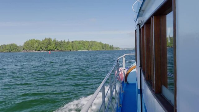 ront view from a boat cruising through coastal waters near Ucluelet, British Columbia. Dynamic motion on the ocean with west coast scenery and moody Pacific Northwest atmosphere.