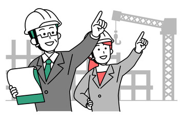 工事現場で遠くを指差すヘルメットをかぶった上司と部下
