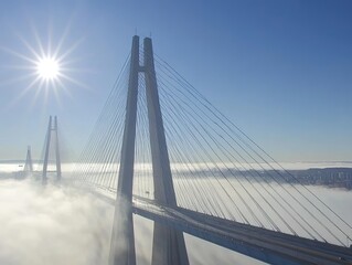 Obraz premium Elevated view of a modern cable-stayed bridge over a dense fog.