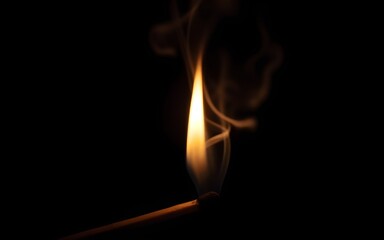 Glowing matchstick with swirling smoke against black background. High quality