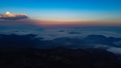 Sunset mountain landscape with warm orange and dark hues, creating a peaceful and relaxed natural...