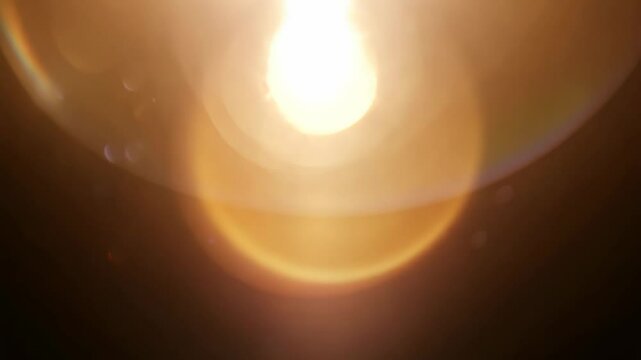 Radiant lens flare transition: abstract light glow and burst progression