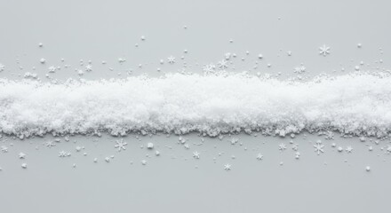 Strip of faux snow with scattered snowflakes on a neutral surface