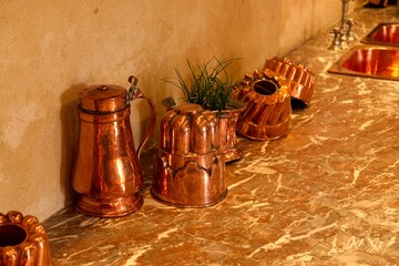 Mortree France - 7 September 2023 - Copper and brass pans and kitchen utensils in the kitchen of Château d'O in Montree France