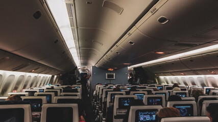 Inside and interior of a plane seats and passengers.