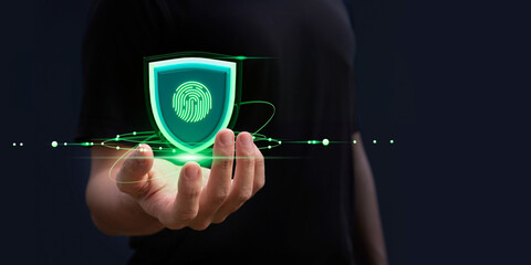 A hand showing Information security or cyber security concept. Green shield. Website, computer...