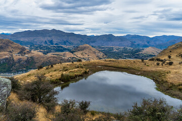 Naklejka premium Panoramic scenery of the Queenstown and Wakatipu basin from a working deer farm above Kelvin Heights