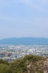 Kyoto, Japan – April 15, 2024: Panoramic view of Kyoto city and surrounding mountains from the summit of Mount Inari, along the path of Fushimi Inari Taisha, one of Japan’s most iconic landmarks.