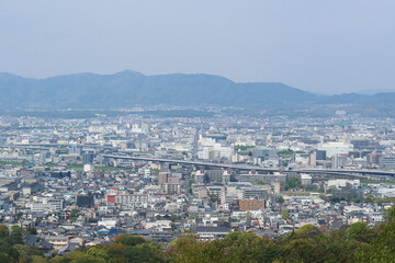 Kyoto, Japan – April 15, 2024: Panoramic view of Kyoto city and surrounding mountains from the summit of Mount Inari, along the path of Fushimi Inari Taisha, one of Japan’s most iconic landmarks.