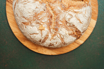 Freshly baked artisan bread resting on a wooden board in a cozy kitchen