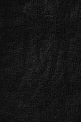A minimalist, high-quality black paper texture with natural soft wrinkles and grain. Perfect for use in posters, album covers, collages, or any design project that requires a distressed or vintage.