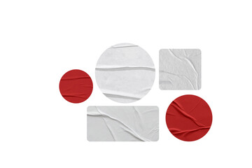 Colorful torn paper sticker shapes on black background, including red, green, blue, yellow and white elements with wrinkled texture.
