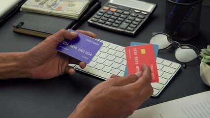 a businessman is checking some credit cards held in his hand to make a transaction. financial technology. business and financial concept