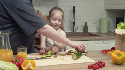 Child learning to prepare healthy snacks with parental guidance in a kitchen setting