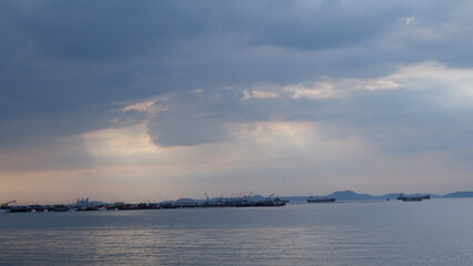 Evening view of half sea half cloud sky with some transport boats