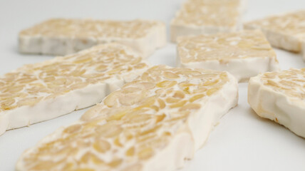slices of tempe indonesian traditional food on white background. food for diet. healthy food tempe indonesia